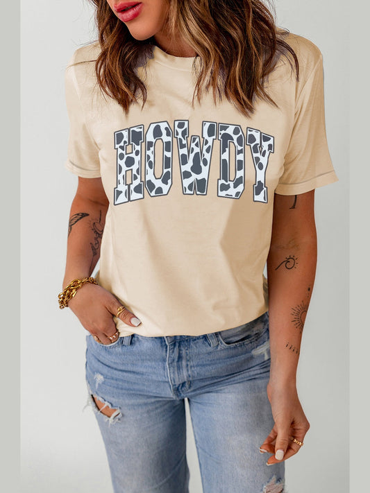 Women Round Neck short sleeve tee in light apricot with "HOWDY" cow print graphic, soft polyester blend fabric