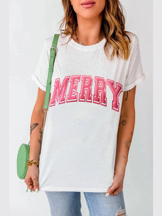 White MERRY Round Neck short sleeve T-shirt with pink lettering, slightly stretchy fabric, basic style, worn with denim jeans and green shoulder bag