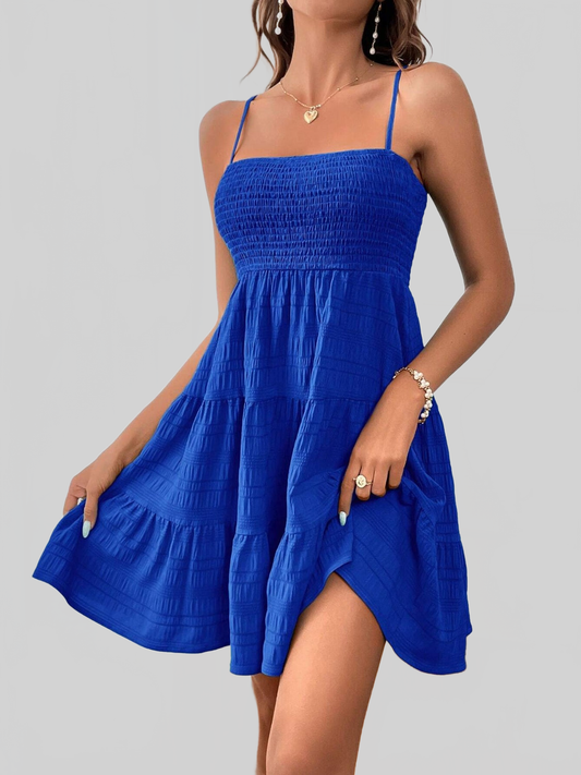 Women Smocked Tiered Sleeveless Mini Summer Dress in royal blue with smocked bodice and tiered skirt, lightweight and sleeveless design.