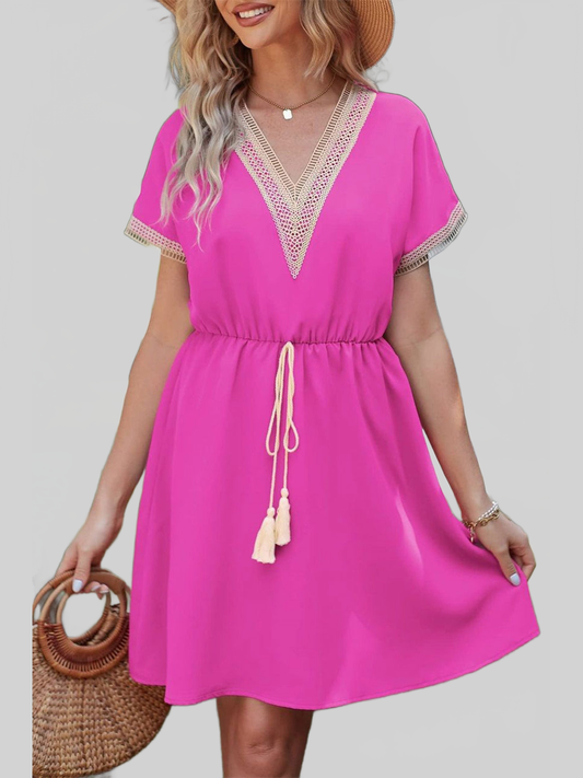Women Tassel V-Neck pink summer dress with short sleeves, tassel drawstring waist, and lace trim on the neckline and sleeves.