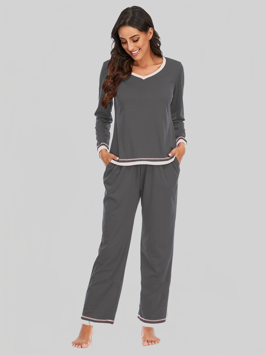 Two-piece lounge set with dark grey cotton-blend fabric, featuring a Women V-Neck Top and matching pants with white and pink trim accents.