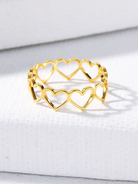 Gold plated stainless steel heart-shaped band with hollowed-out design, a stylish Women Metal hollowed-out rings accessory.