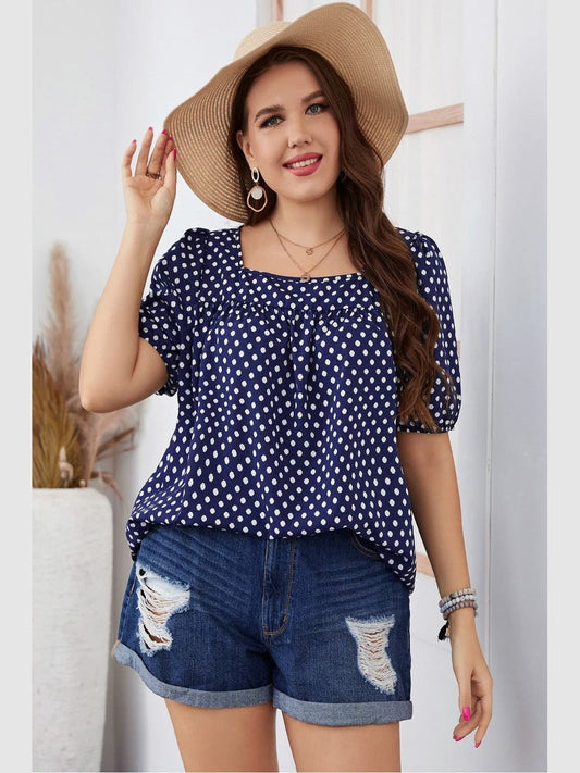 Plus size woman wearing navy polka dot square neck short sleeve blouse and denim shorts