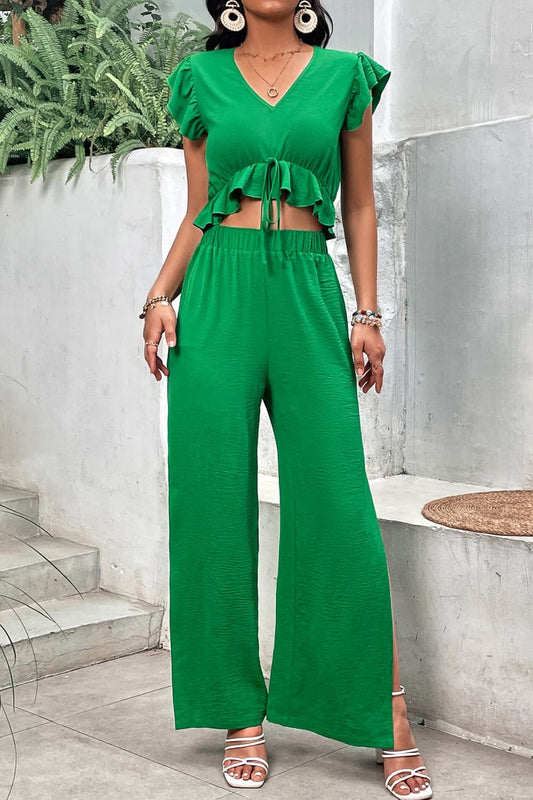 Women V-neck ruffle hem top with cap sleeves and slit pants set in solid green polyester