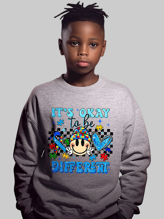 Child wearing a gray sweatshirt with a colorful design and text on a light gray background NicholesGifts