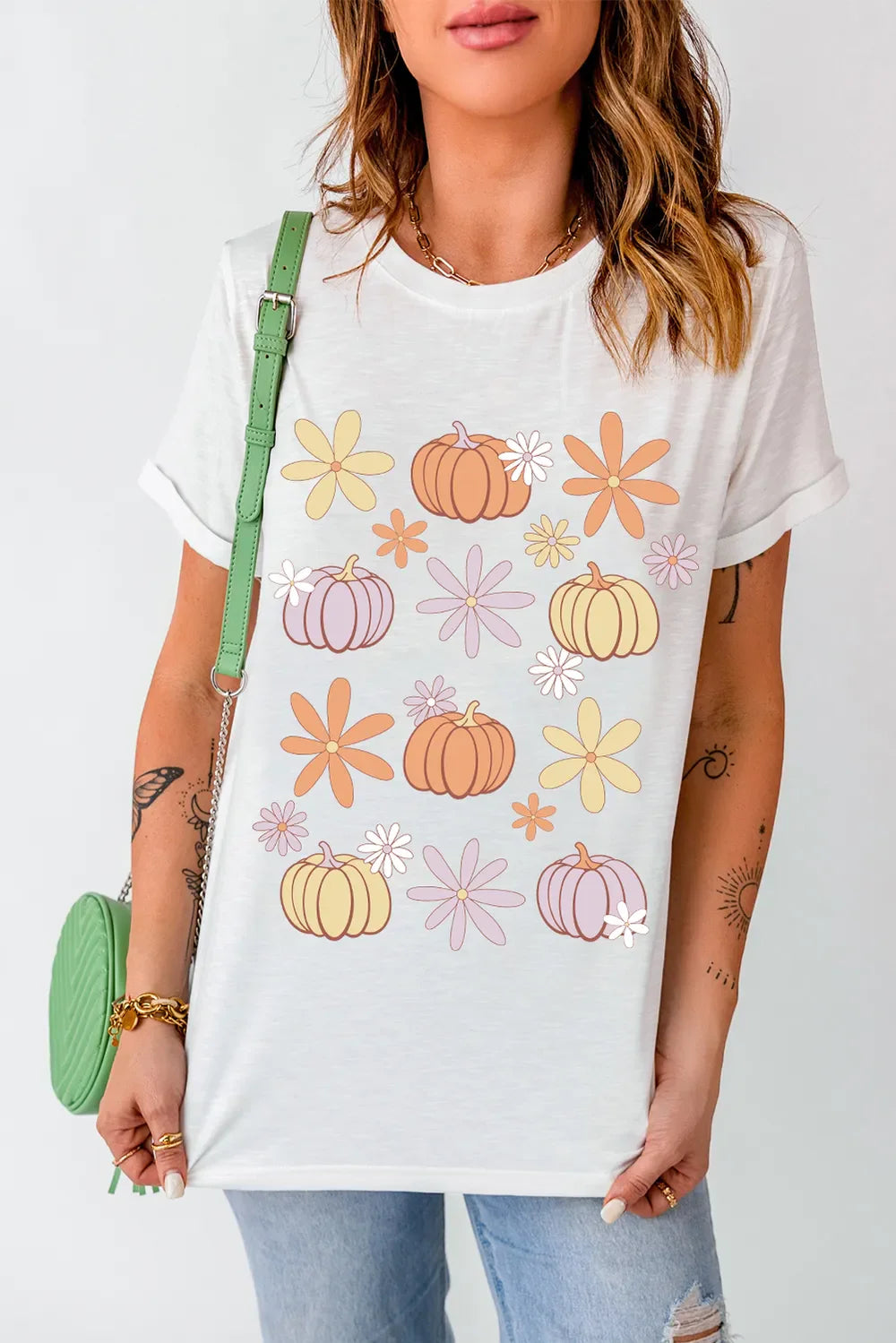 White round neck short sleeve t-shirt with pumpkin and flower graphic print, slightly stretchy polyester cotton blend fabric.