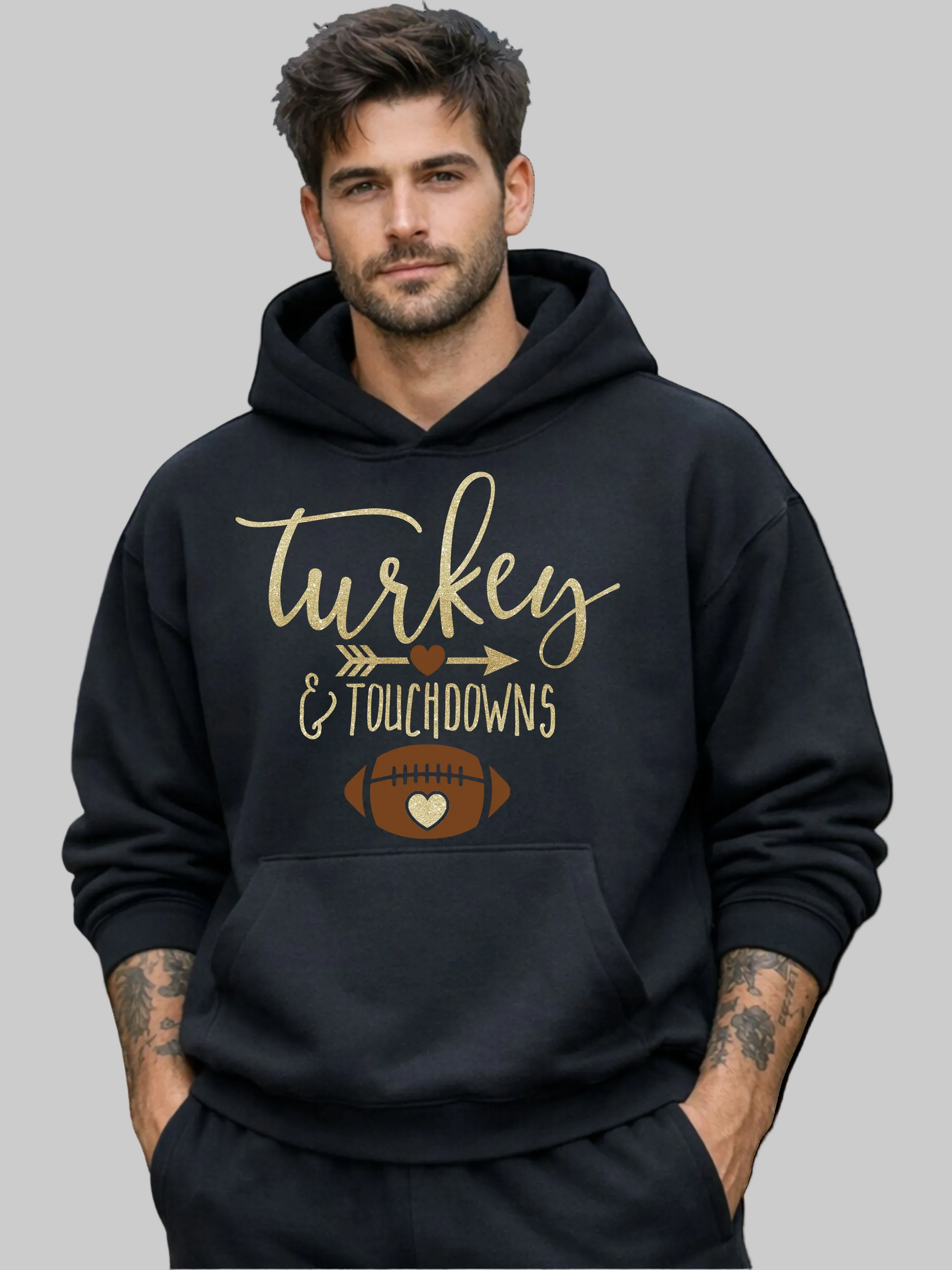 A man wearing a black pullover hoodie with a 'Turkey & Touchdowns' football graphic on the front, set against a plain white background.