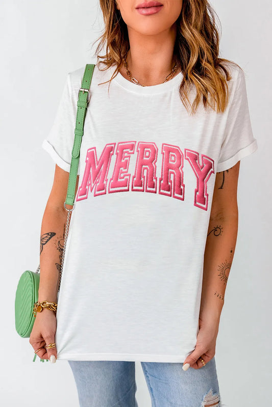 White MERRY Round Neck short sleeve T-shirt with pink lettering, slightly stretchy fabric, basic style, worn with denim jeans and green shoulder bag