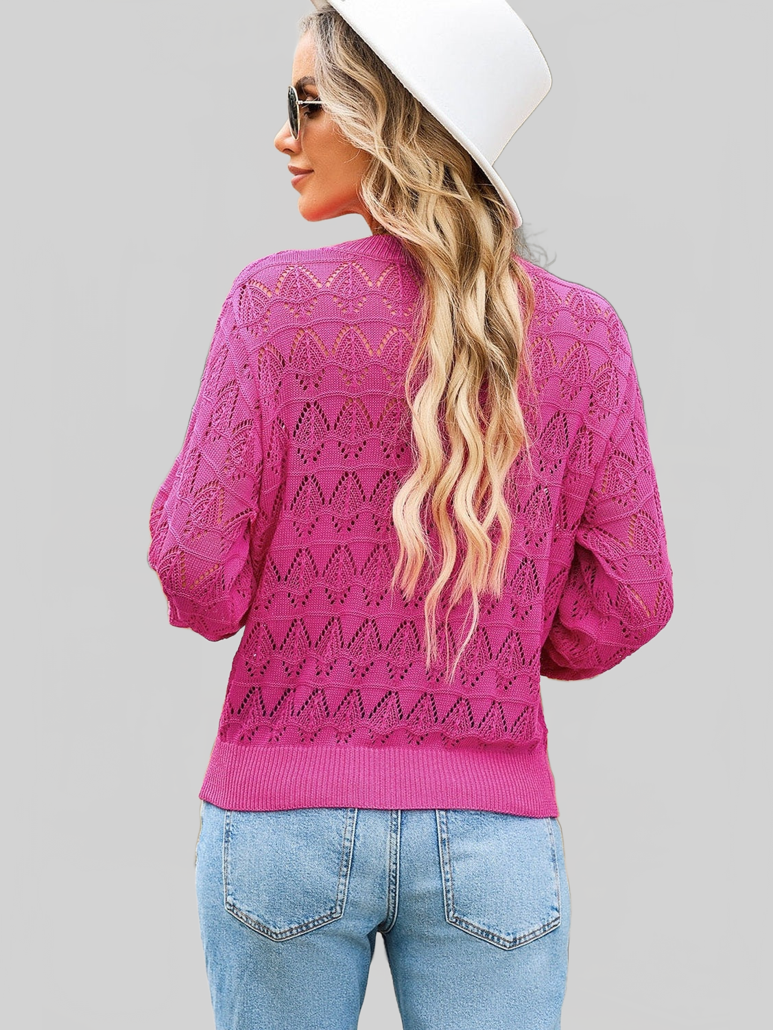 Bright pink lightweight knit sweater with openwork pattern and ribbed hem, styled as a Women openwork V-Neck cardigan.
