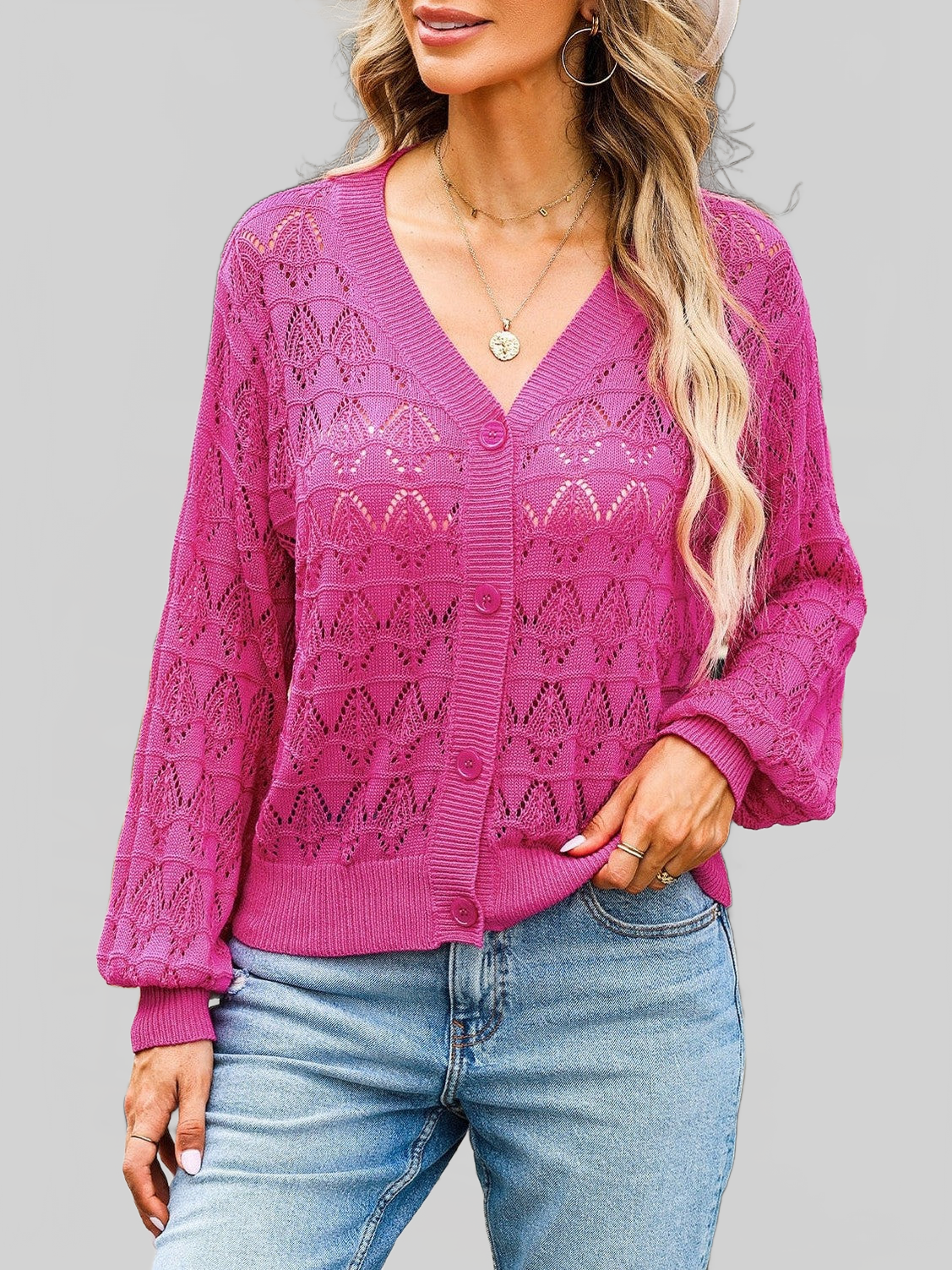 Women openwork V-Neck cardigan in vibrant pink with delicate open-knit pattern, button-up front, and ribbed cuffs and hem.
